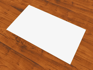 Blank business card resting on wood surface.