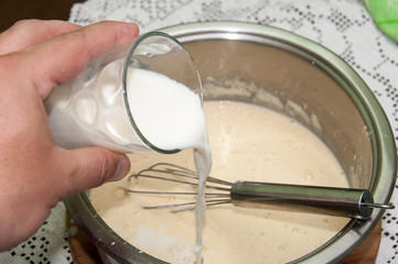 Mixing flour egg and milk for pancakes