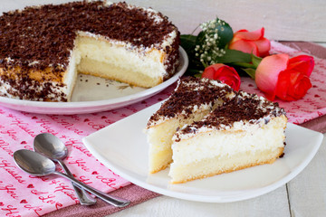 Cake, cheese souffle and cream on a white wooden table