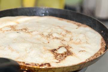 Frying pancake in the frying pan