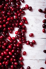  fresh cornel berries on wooden table
