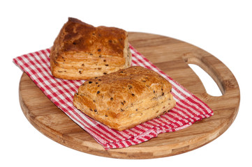 Puff pastry on the kitchen tablecloth and wooden board