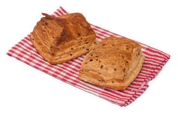 Pastry buns on the red kitchen tablecloth