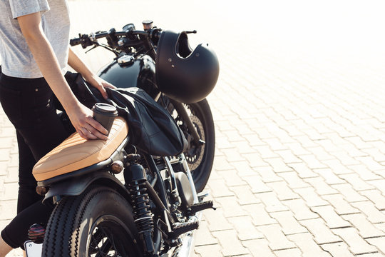 Fototapeta girl with cup of coffee  and vintage custom motorcycle