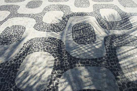 Ipanema Beach sidewalk tiles Rio de Janeiro with palm tree shadows