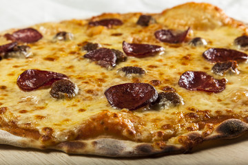 Pizza with salami and pineapple