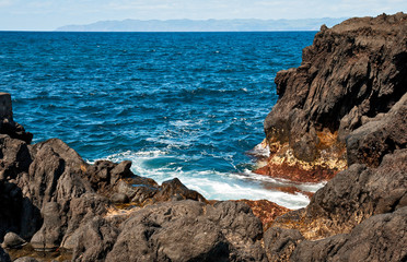 The stiffened lava on the bank of volcanic island Pico