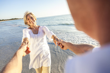 Happy Senior Couple Walking Holding Hands Tropical Beach