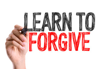 Hand with marker writing: Learn To Forgive