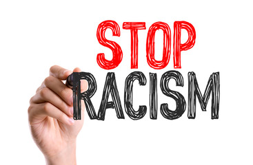 Hand with marker writing: Stop Racism