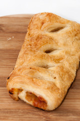 Stuffed pizza puff pastry on the wooden board