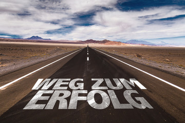 Road to Success (in German) written on desert road