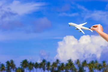 Little white airplane model in female hand background of