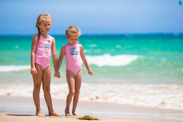 Adorable little girls having fun during beach vacation