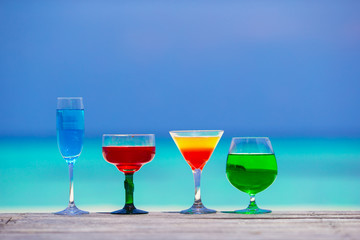 Colorful exotic tasty cocktails in outdoor cafe background