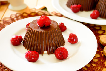Homemade custard ice cream, covered with chocolate and cherries