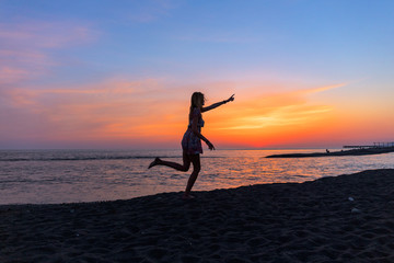 Portrait of beautiful young woman on the beach sunset