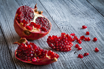 Juicy pomegranate fruit over wooden table