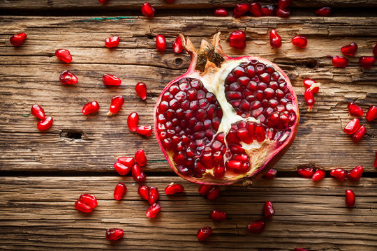 Juicy pomegranate fruit over wooden table