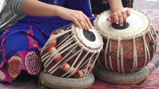 Indian woman playing Indian musical instruments Tabla Punjabi drums