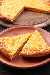 Slices of tasty cheese pizza on plate close up