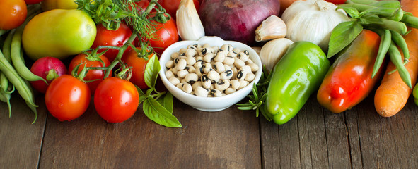 Black eyed peas in a bowl and vegetables