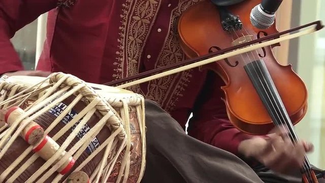 Indian man play music on musical instrument Violin
