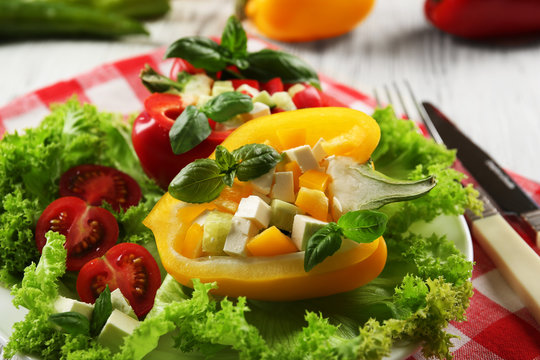 Fresh green salad in pepper on table close up