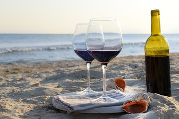 Wine bottle and glasses on the seashore