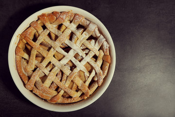 Homemade apple pie on wooden background