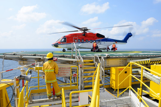 The landing officer are loading baggage of passenger to helicopt