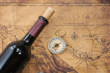 bottle of wine  on the background of old maps