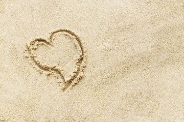 Love sign writing on sand beach.