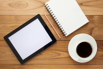 Cup of hot coffee and diary on wood table background