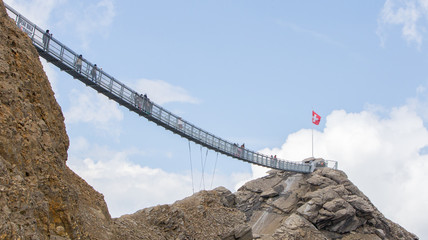 LES DIABLERETS, SWIZTERLAND - JULY 22: People walk at the Glacie - obrazy, fototapety, plakaty