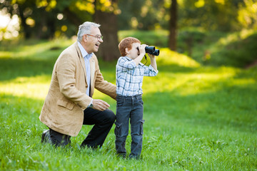 Grandfather and grandson in park