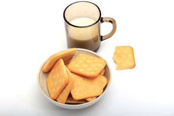 Fototapeta na wymiar Crackers with a glass of milk on a white background