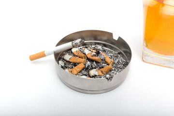 Glass of whiskey with ice. With an ashtray and a cigarette on a