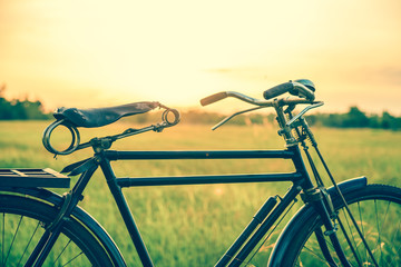 beautiful landscape image with Bicycle at sunset in vintage tone