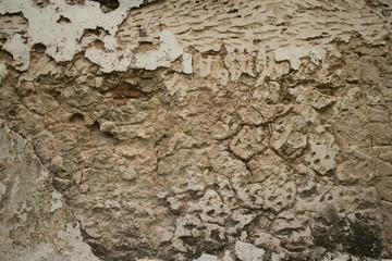 Horizontal view of Colonial stucco wall in Asia with deep fissures in the surface