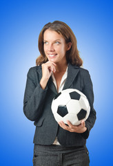 Businesswoman with football on white