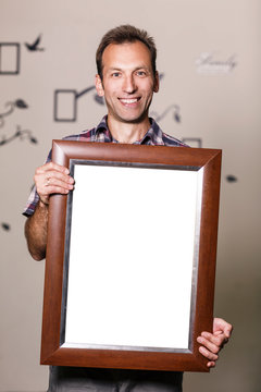 Happy man holding portrait frame