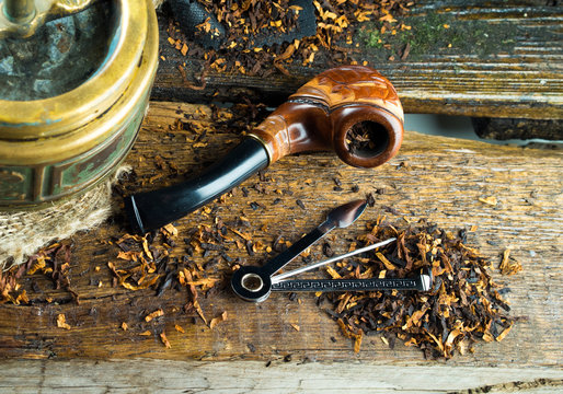 wooden smoking pipe and ashtray vintage old lie on the table
