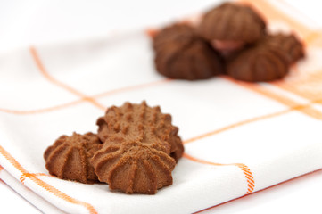 Brown chocolate cookies on the kitchen tablecloth