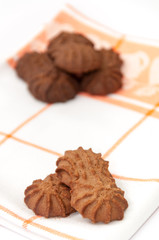 Brown chocolate cookies on the kitchen tablecloth