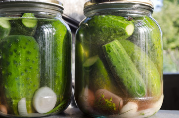 Pickled homemade cucumbers in the glass jar, preserved vegetables