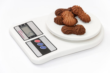Chocolate cookies on the digital kitchen scale