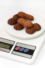 Chocolate cookies on the digital kitchen scale