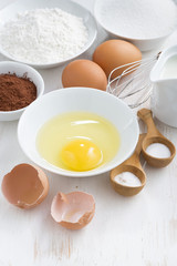 ingredients for baking on a white wooden table, vertical