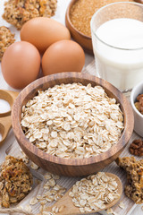 oat flakes and ingredients for making cookies on white table